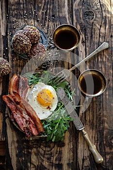 Breakfast with fried egg and becon in rustic stile