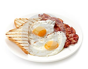 Breakfast with fried eggs, bacon and toasts