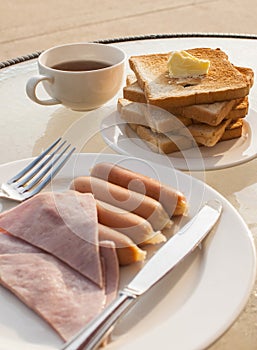 Breakfast with fried eggs, butter toasts and coffee