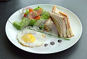 Breakfast with fried eggs and sandwiches