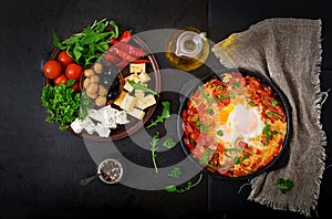 Breakfast. Fried eggs with vegetables - shakshuka in a frying pan