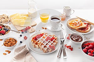 Breakfast with granola berry nuts, waffle, toast, jam, chocolat
