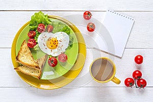 Breakfast with heart-shaped fried egg, toast, cherry tomato, let