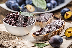 Breakfast from homemade plum jam bread and ripe plums.