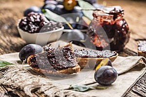 Breakfast from homemade plum jam bread and ripe plums.