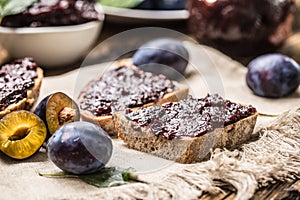 Breakfast from homemade plum jam bread and ripe plums.