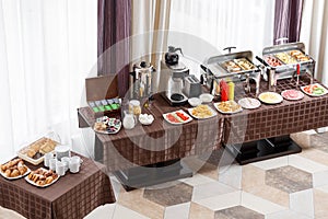 Breakfast at the hotel. Buffet Table with dishware waiting for guests