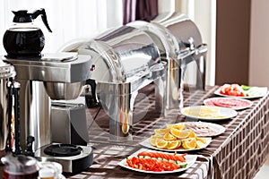 Breakfast at the hotel. Buffet Table with dishware waiting for guests