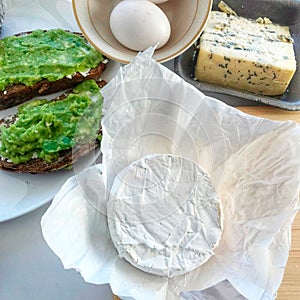 Breakfast ingredients recipe and blue cheese and brie cheese with toast avocado and eggs