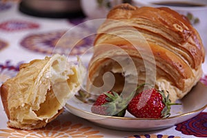 Breakfast made of croissant and strawberries