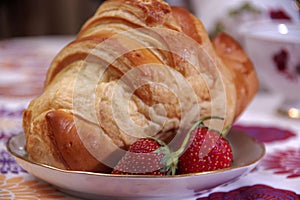 Breakfast made of croissant and strawberries
