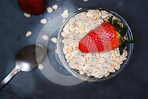 Breakfast made up of dry cereal with red strawberries