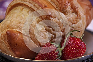 Breakfast mae of croissant and strawberries