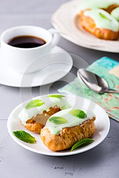Breakfast with mint eclairs and cup of coffee