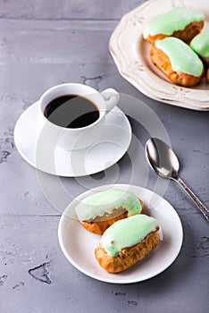 Breakfast with mint eclairs and cup of coffee