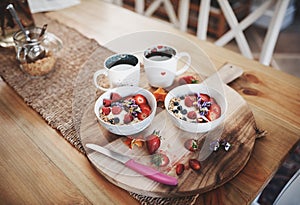 Breakfast, muesli cereal and diet above on table of fruit, wheat or oats and organic food for wellness or at home. Bowls