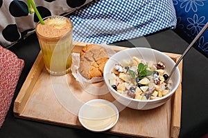 Breakfast. Oatmeal with fruit, biscuits and fresh juice