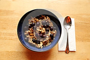 Breakfast with oatmeal, walnuts, milk, and blueberries