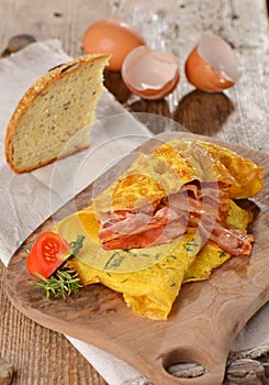 Breakfast omelette with ham, bacon photo