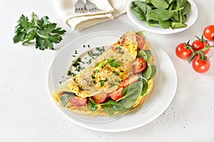 Breakfast omelette with spinach and tomato