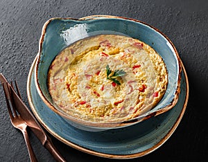 Breakfast, Omelette with vegetables and herbs on plate over black table surface. Healthy food