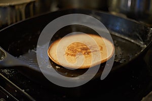 Breakfast pancake cooking on the pan