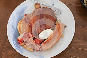 Breakfast pancakes bacon and sausages on wooden table. Homemade Continental breakfast at home kitchen