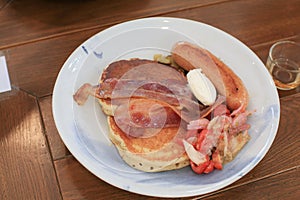 Breakfast pancakes bacon and sausages on wooden table. Homemade Continental breakfast at home kitchen,