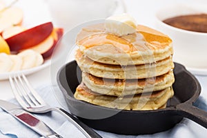 Breakfast with pancakes, honey and fruits