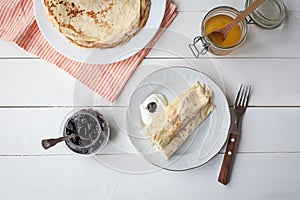 Breakfast with pancakes, jam, honey