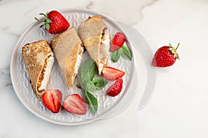 Breakfast with Pancakes with sauce, strawberries. White background