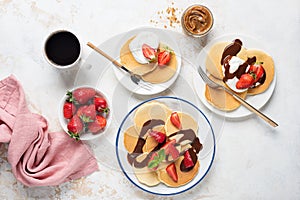 Breakfast pancakes with strawberries, yogurt and chocolate sauce