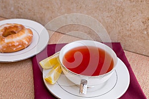 Breakfast with pastries, and hot tea with lemon.