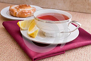 Breakfast with pastries, and hot tea with lemon.