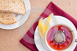 Breakfast with pastries, and hot tea with lemon.