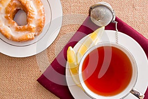 Breakfast with pastries, and hot tea with lemon.