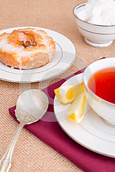 Breakfast with pastries, and hot tea with lemon.