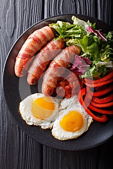 Breakfast Pigs in blankets fried sausages wrapped in bacon, eggs