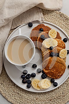 Breakfast platter with coffee latte and oatmeal pancakes