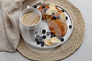 Breakfast platter with coffee latte and oatmeal pancakes