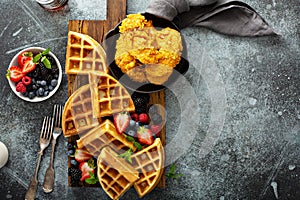 Breakfast platter with waffles, berries and chicken