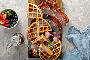 Breakfast platter with waffles, berries and bacon