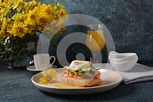 Breakfast with sandwich with cereals bread and salmon, soft cheese and poached eggs