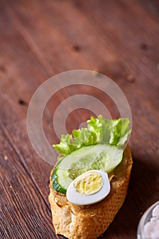 Breakfast sandwich with homemade paste, vegetables and fresh greens, shallow depth of field