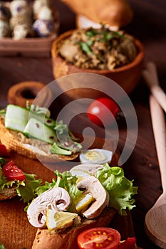 Breakfast sandwich with homemade paste, vegetables and fresh greens, shallow depth of field