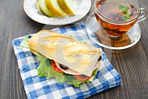 Breakfast with sandwich, tea and melon