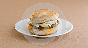 Breakfast sausage egg and cheese biscuit on plate