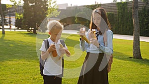 Breakfast of schoolchildren in the school yard. Banana and juice for students.