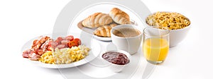 Breakfast with scrambled eggs, bacon, tomatoes,coffee,orange juice ,croissant and corn flakes isolated