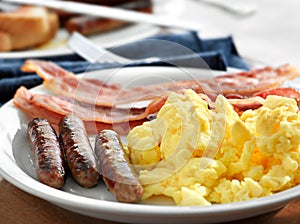 Breakfast - scrambled eggs, sausage, and bacon photo